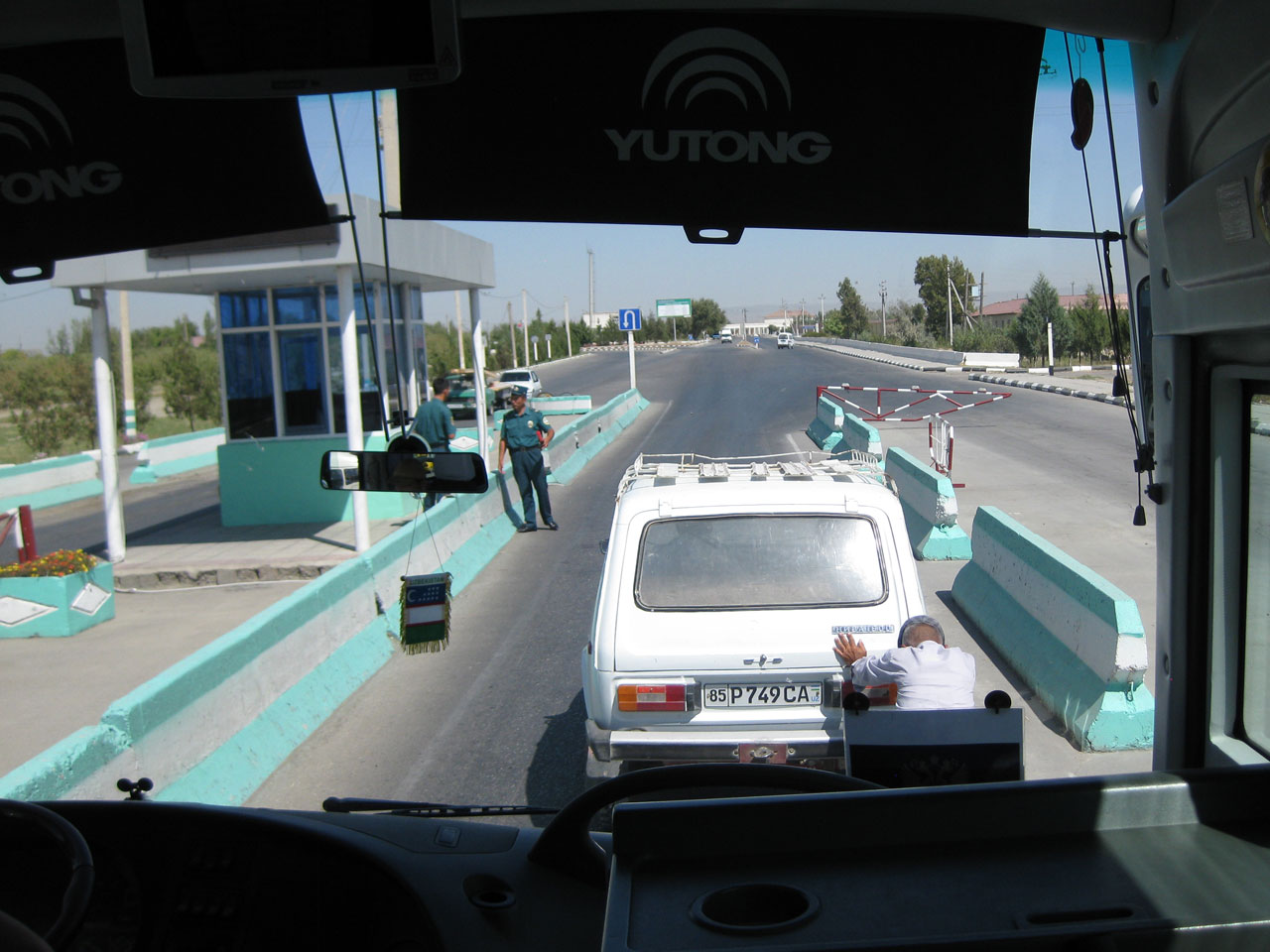 Man pushing his Lada through a police checkpoint, Uzbekistan